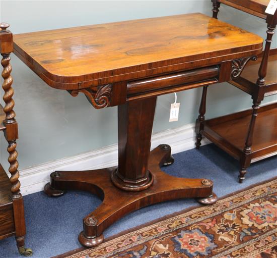 An early Victorian rosewood pedestal card table, with rectangular folding top, on octagonal tapering support, W.91cm